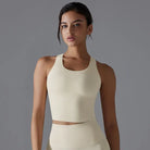 Young woman wearing a cream-colored sleeveless crop top.