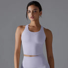 Young woman wearing a white athletic crop top.