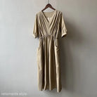 Beige Retro V Neck Pleated Dress with three-quarter sleeves and side pockets on hanger