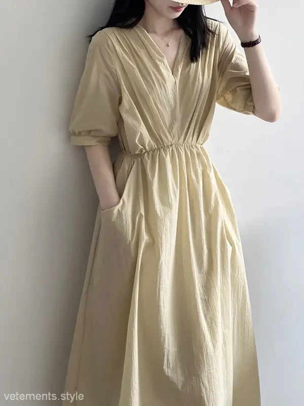 Pale yellow retro V neck pleated dress with short sleeves and cinched waist