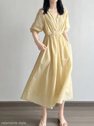 Pale yellow Retro V Neck pleated dress featuring puffed sleeves and cinched waist