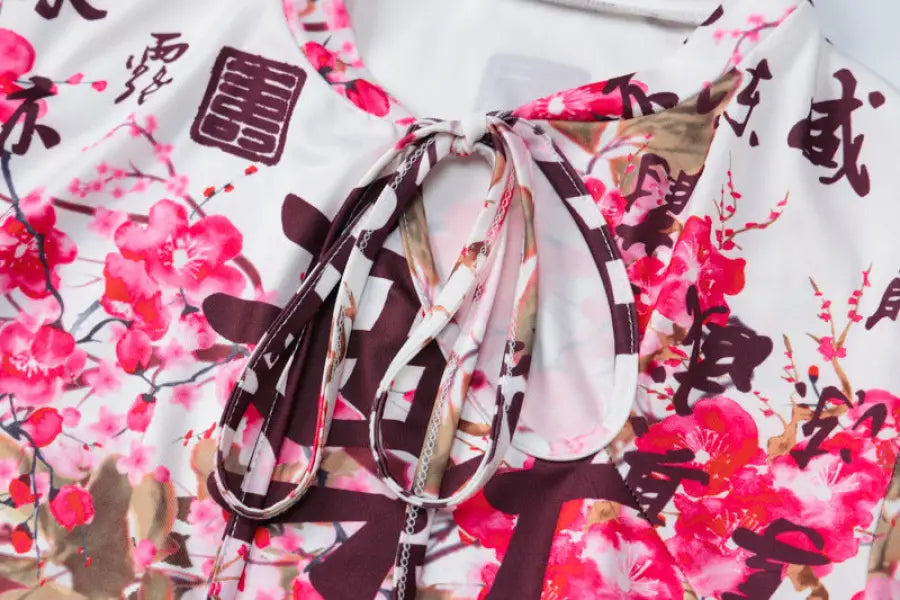 Floral-patterned fabric with Chinese characters and a tied ribbon detail.