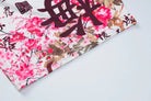 Decorative fabric or paper with cherry blossom design and Chinese characters.