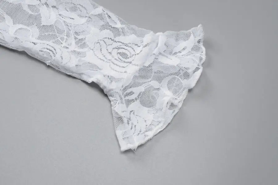 Delicate white lace fabric with a floral pattern.