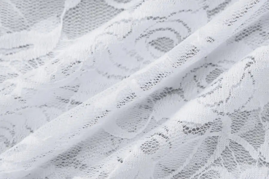 Delicate white lace fabric with floral patterns.