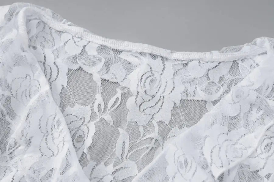 Delicate white lace fabric with a floral pattern.