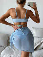 Light blue two-piece outfit consisting of a crop top and wrap skirt.