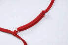 Red fabric strap or band with metal fasteners.