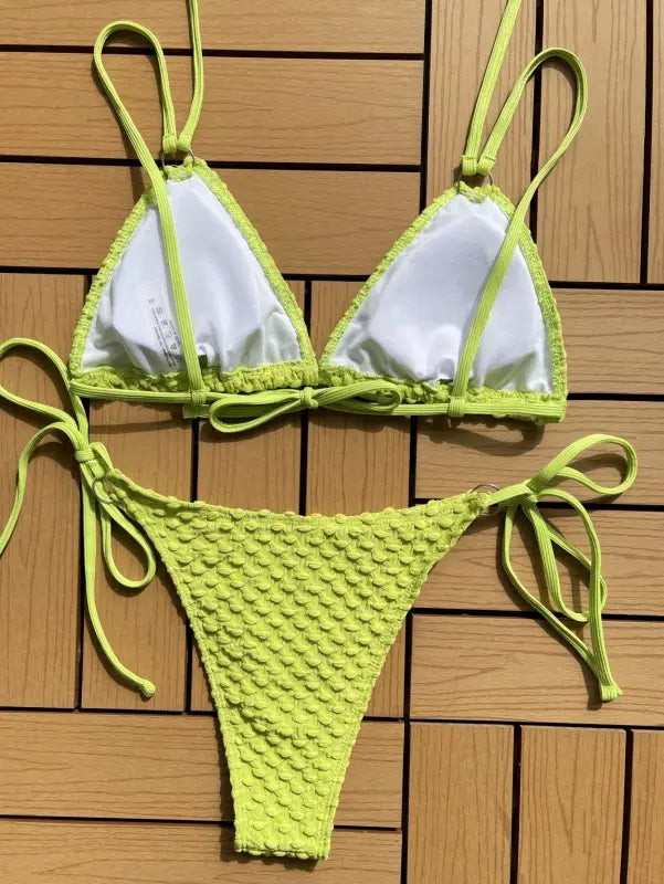 Lime green and white string bikini swimsuit with textured bottoms.