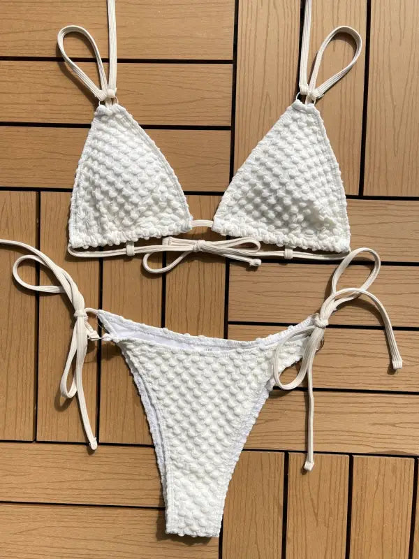 White textured bikini with triangle top and tie-side bottom.