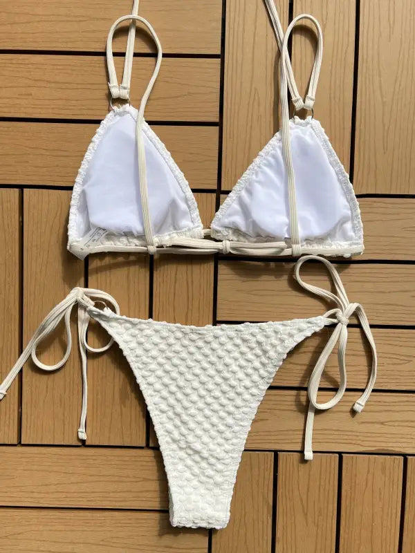 White string bikini with a triangle top and textured bottom.