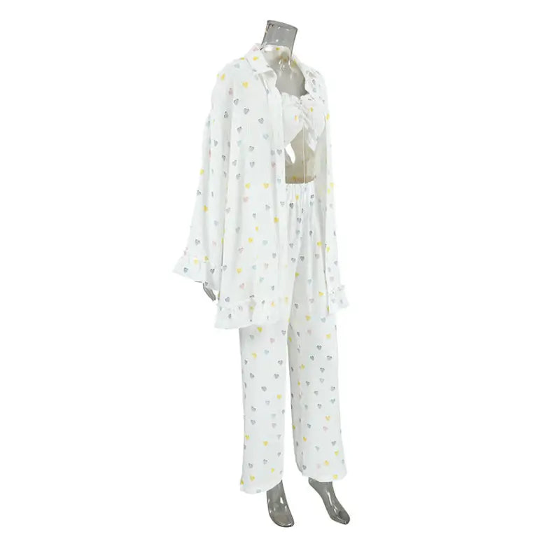 White pajama set with colorful polka dot pattern and ruffled collar.