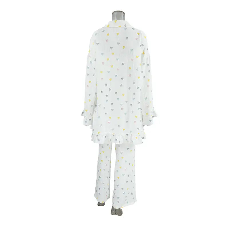 White pajama set with small yellow and gray heart patterns.