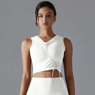 White sleeveless crop top with a gathered front detail and V-neckline.