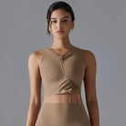 Tan sleeveless crop top with ruched detailing across the front.