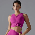 Bright pink sleeveless crop top with a lace-up front detail.