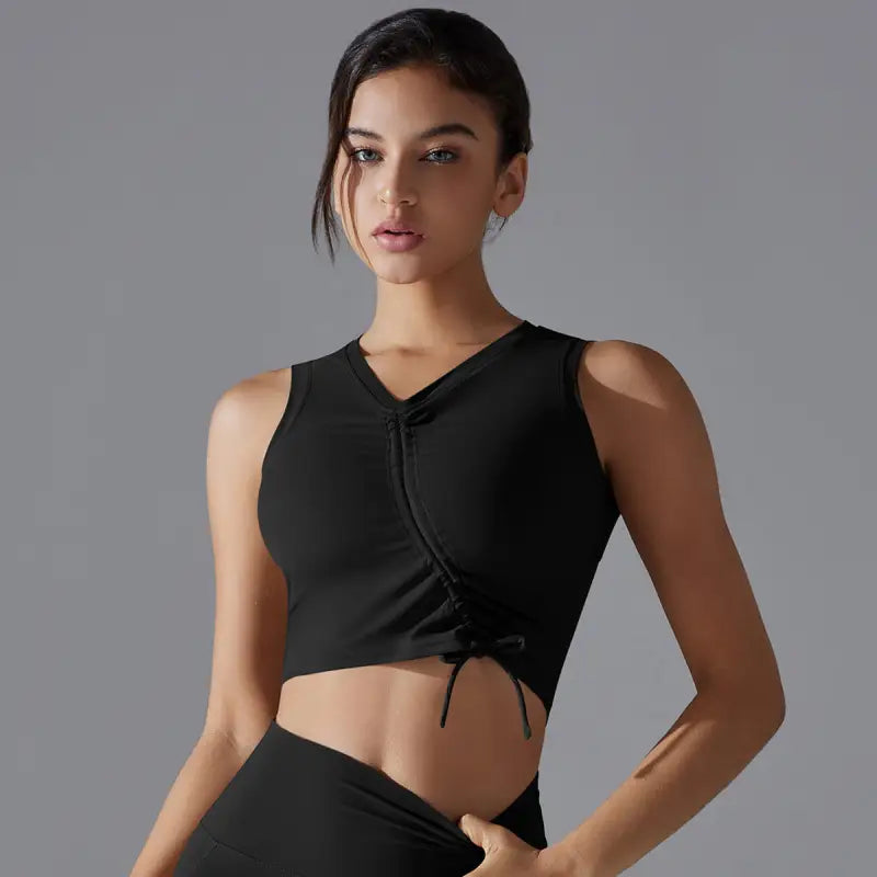 Black sleeveless crop top with a drawstring detail at the bottom.