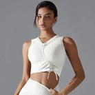 White sleeveless crop top with a lace-up front detail.