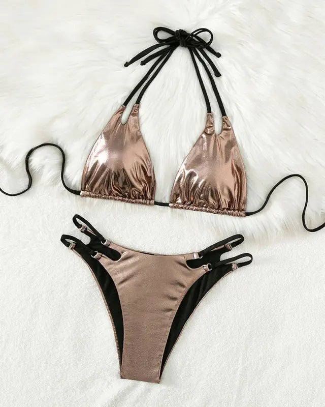 Rose gold metallic bikini with black straps and ties.