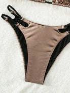 Two-tone bikini bottom with adjustable side straps.