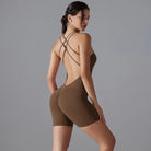 Brown bodysuit with criss-cross back straps and short legs.